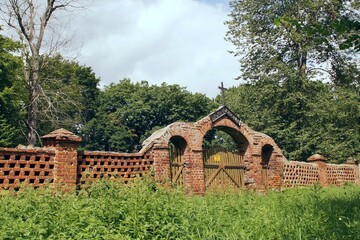 gate and wall of an old village cemetery