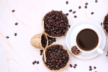 Wall Mural - coffee beans andcup of coffee on wooden table cup