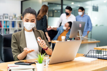 Asian businesswoman cleaning hand in new normal office