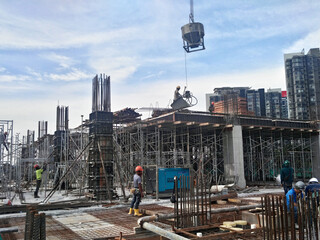 Sticker - KUALA LUMPUR, MALAYSIA -AUGUST 23, 2019: Construction workers working at the construction site in Malaysia during the daytime. They are required to wearing appropriate safety gear to avoid an accident