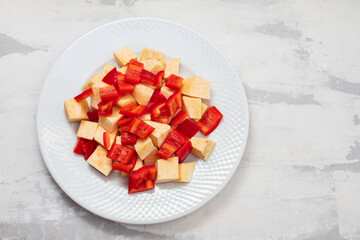 Poster - uncooked sweet potato and red pepper on white plate