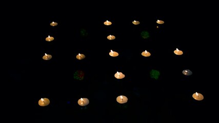 Wall Mural - Diyas decorated candles are lit in sawastik formation at night.
