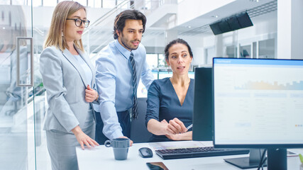 Poster - In Bright Modern Office: Office Worker Sitting and Working at Her Desktop Computer, Discusses Problem Solution with Her Project Manager and Team Leader. Young Businessmen Planning and Problem Solving