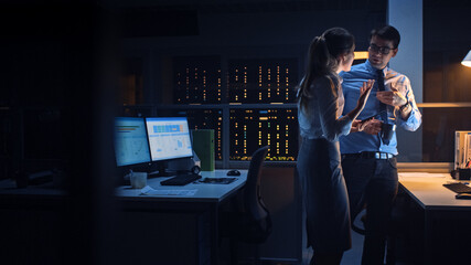 Poster - Portrait of Businessman and Female Project Manager Talking and Discussing Project, Account Handling and Strategic Moves. Professional People Late at Night in Big Corporate Office