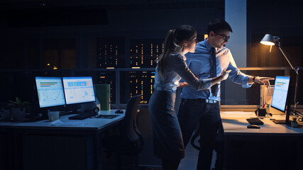 Poster - Portrait of Businessman and Female Project Manager Talking and Discussing Project, Account Handling and Strategic Moves. Professional People Late at Night in Big Corporate Office