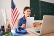 © Yakobchuk Olena - Jolly woman enjoying online studies at school