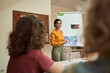 © Yakobchuk Olena - Happy pretty woman enjoying art lesson with pupils