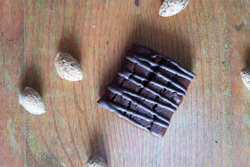 Chocolate and nuts on wooden table, zenith view