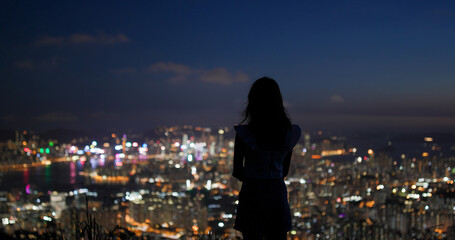 Wall Mural - Woman enjoy the city view under sunset