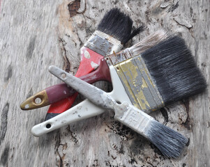 Old paint brush on old wood board.