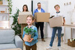 © Prostock-studio - Happy Family Carrying Boxes Moving To New House Standing Indoors