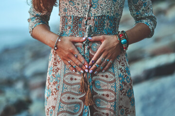 Wall Mural - Bohemian chic gypsy woman with manicure wearing jewelry accessories and dress. Boho detail close up