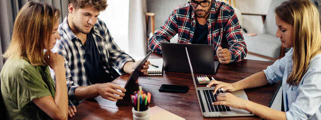 Group of young people working together. Creative business people in modern office. Hipster team in coworking. Young modern colleagues.