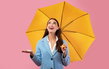 Portrait of beautiful young girl holding yellow umbrella