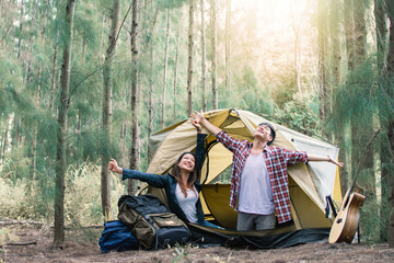 asian couple wake up while camping in forest