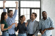 © fizkes - Overjoyed happy diverse business team celebrating success, achievement together, laughing and rejoicing, smiling excited employees colleagues screaming with joy, standing in office room