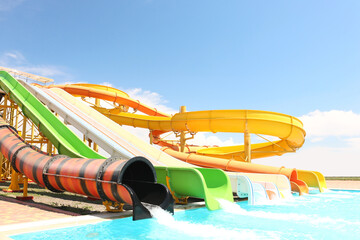 Sticker - Different colorful slides in water park on sunny day