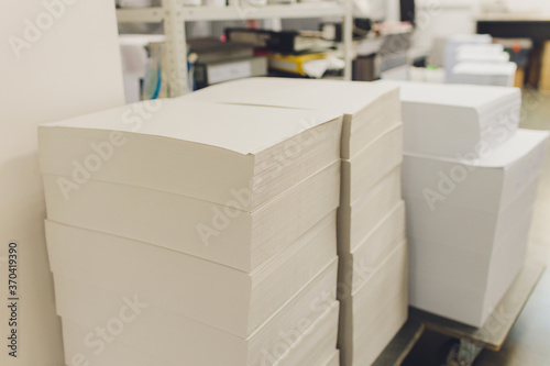 stacks of printed sheets of cardboard on wooden pallets closeup. printing industry.