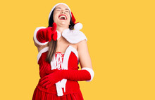 Young Beautiful Caucasian Woman Wearing Santa Claus Costume Laughing At You, Pointing Finger To The Camera With Hand Over Body, Shame Expression