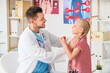 © Pixel-Shot - Doctor examining little girl with thyroid gland problem in clinic