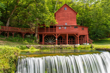 Poster - An old red grist mill with a small waterfall.