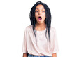 Cute african american girl wearing casual clothes scared and amazed with open mouth for surprise, disbelief face