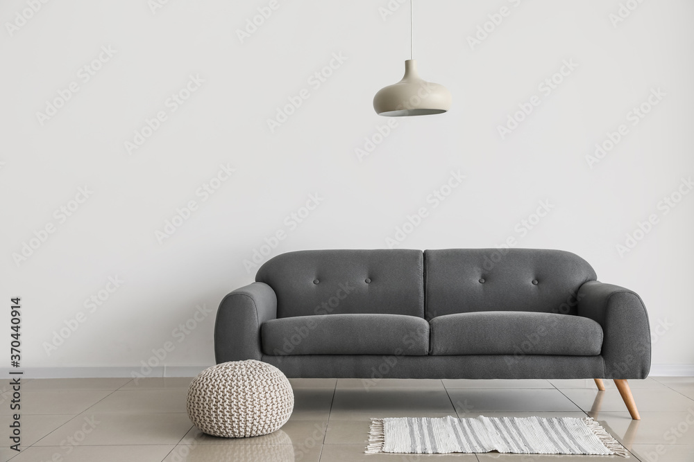 Sofa near wall in interior of living room