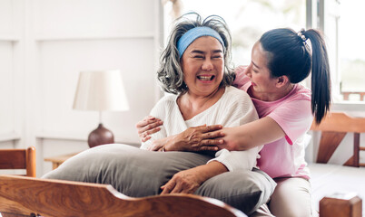 Portrait of enjoy happy love asian family senior mature mother and young daughter smiling laughing embracing and having fun together in moments good time at home