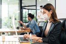 Asian Young Businesswoman Wearing Mask Working On Computer In Office