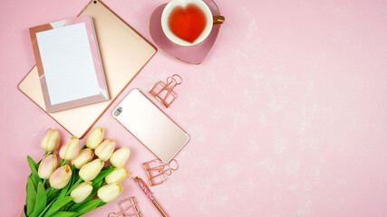 Wall Mural - Feminine pink theme desktop workspace with rose gold tablet and phone devices on stylish textured background. Top view blog hero header creative composition flat lay.