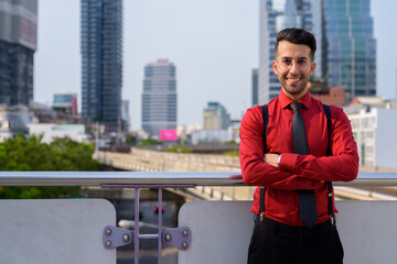 Wall Mural - Young handsome Persian businessman exploring the city