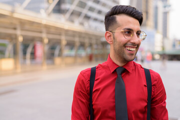 Wall Mural - Young handsome Persian businessman exploring the city