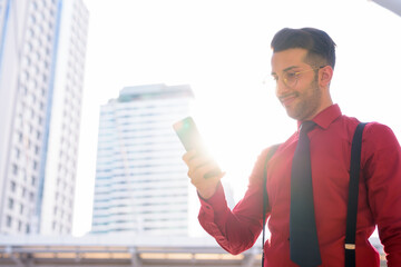 Wall Mural - Young handsome Persian businessman exploring the city