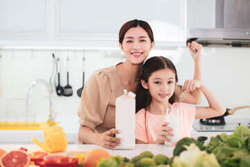 Wall Mural - mother and child drinking milk at the kitchen