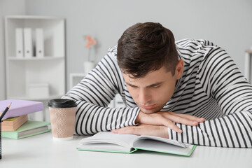 Wall Mural - Tired student sleeping at table