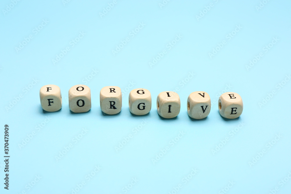 Cubes with word FORGIVE on color background - obrazy, fototapety, plakaty 