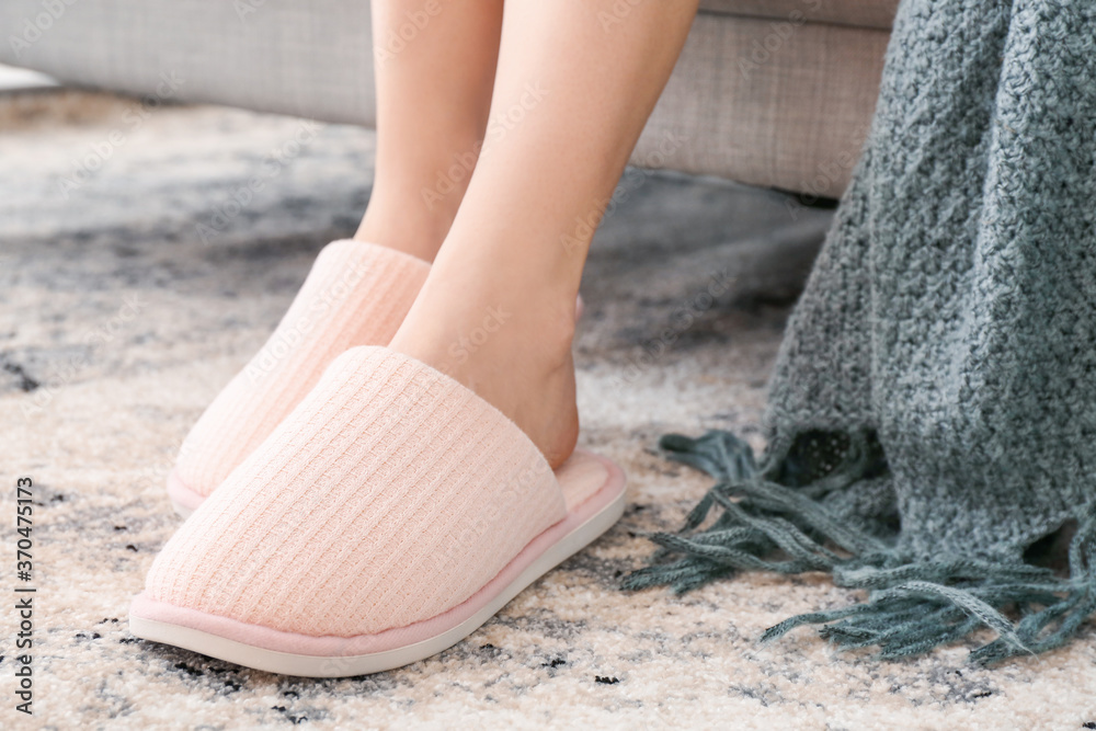 Young woman in soft slippers at home - obrazy, fototapety, plakaty 