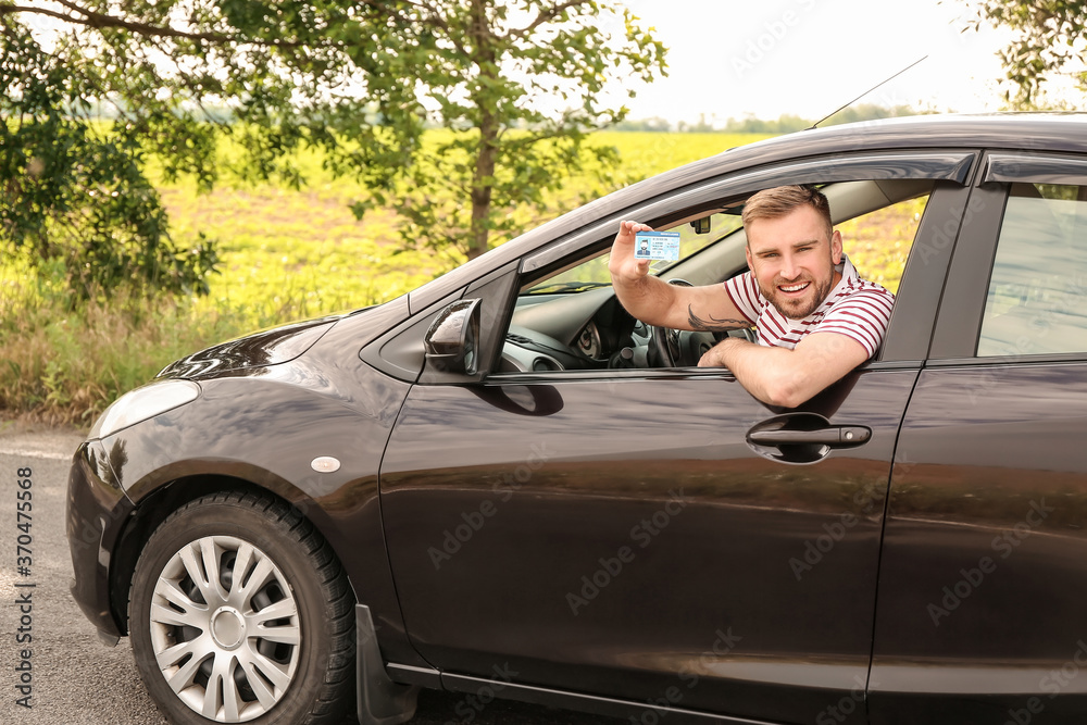Happy young man after successful passing of driving license test