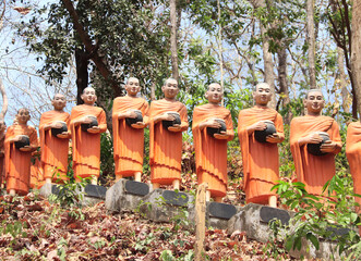 Poster - Row statues of buddhist monks with alms bowl, Cambodia, Asia