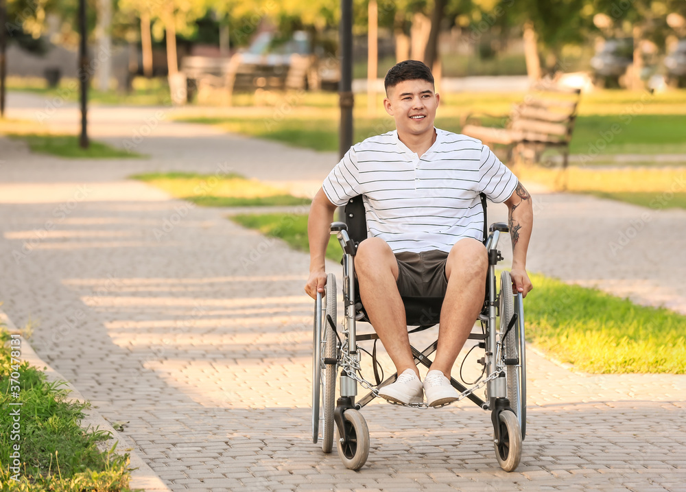 Young man in wheelchair outdoors