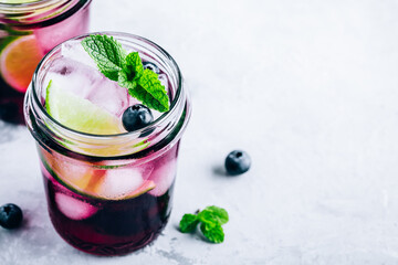 Wall Mural - Blueberry Mojito with lime and fresh mint. Iced cold summer drink in glass jar.