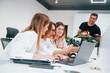 © standret - Front view of group of business people in formal clothes working indoors in the office