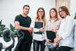 © standret - Group of business people in formal clothes standing indoors in the office together