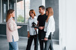 © standret - Group of business people in formal clothes that standing indoors