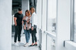 © standret - Group of people standing indoors together and looks at photos on camera