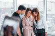 © standret - Group of people standing indoors together and looks at photos on camera