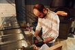 © standret - Chef in white clothes preparing delicious pizza on the kitchen of restaurant