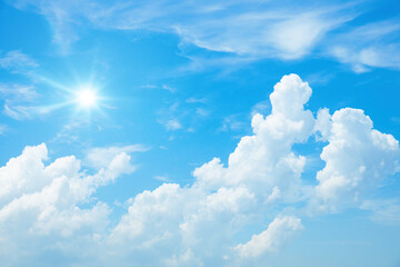 Wall Mural - typical blue sky with sun and clouds background