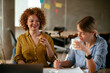 © JustLife - Businesswomen working on a new project. Colleagues discussing about problem they have to solved...