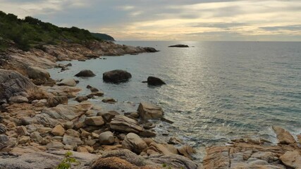 Wall Mural - Static shot to rocky coastline at koh Phangan island in sunset time, Thailand